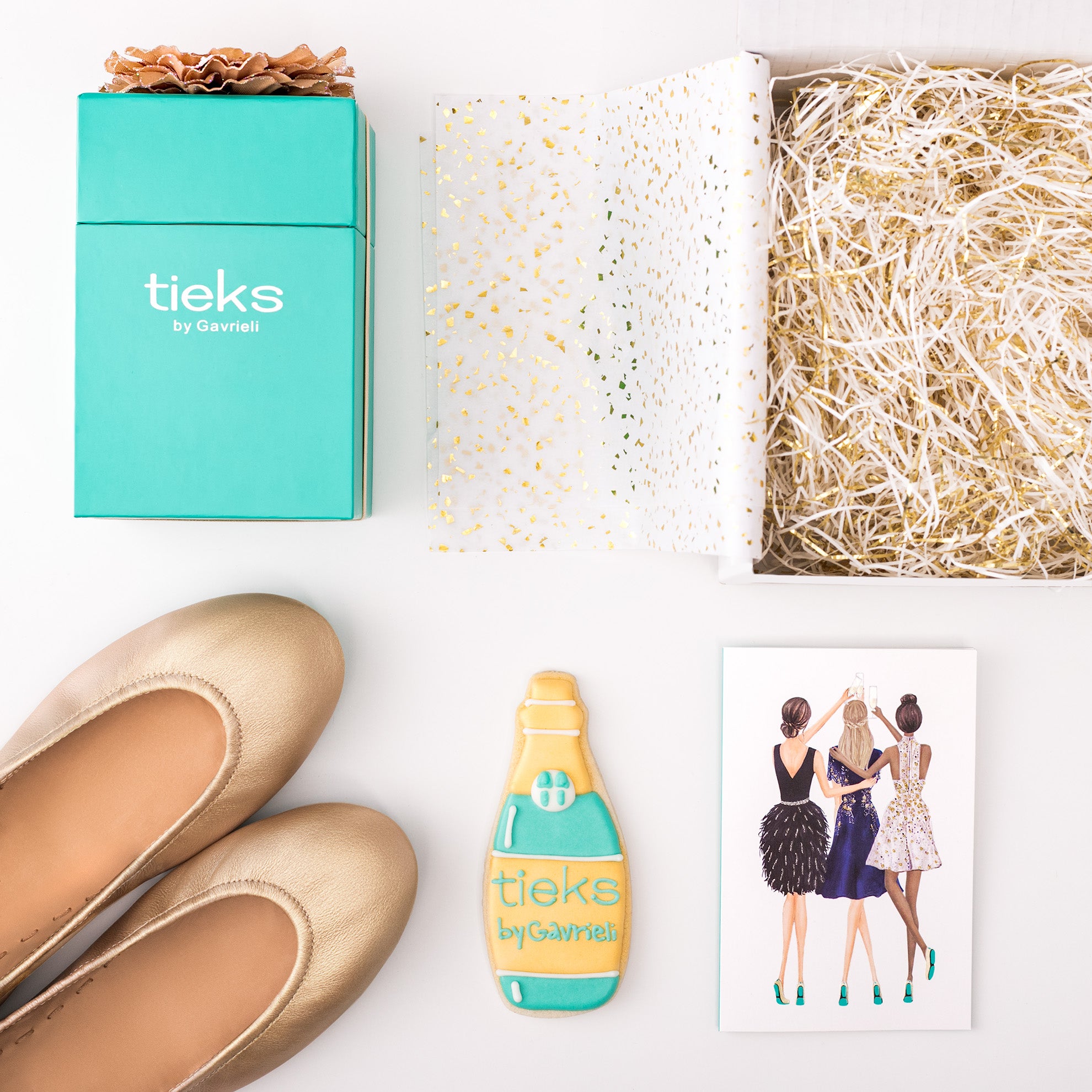 flat lay of champagne tieks flats and the goodies that it came with