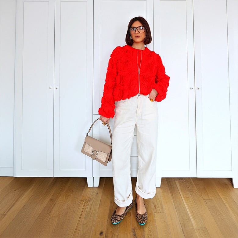 leopard print tieks ballet flats styled with white pants and an orange sweater