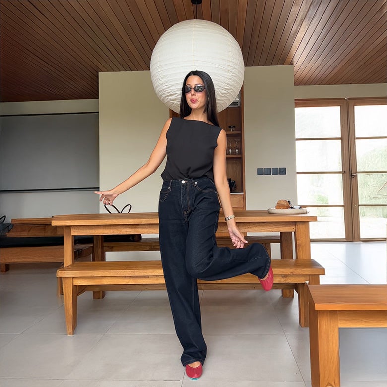 red tieks ballet flats styled with dark denim and a black top