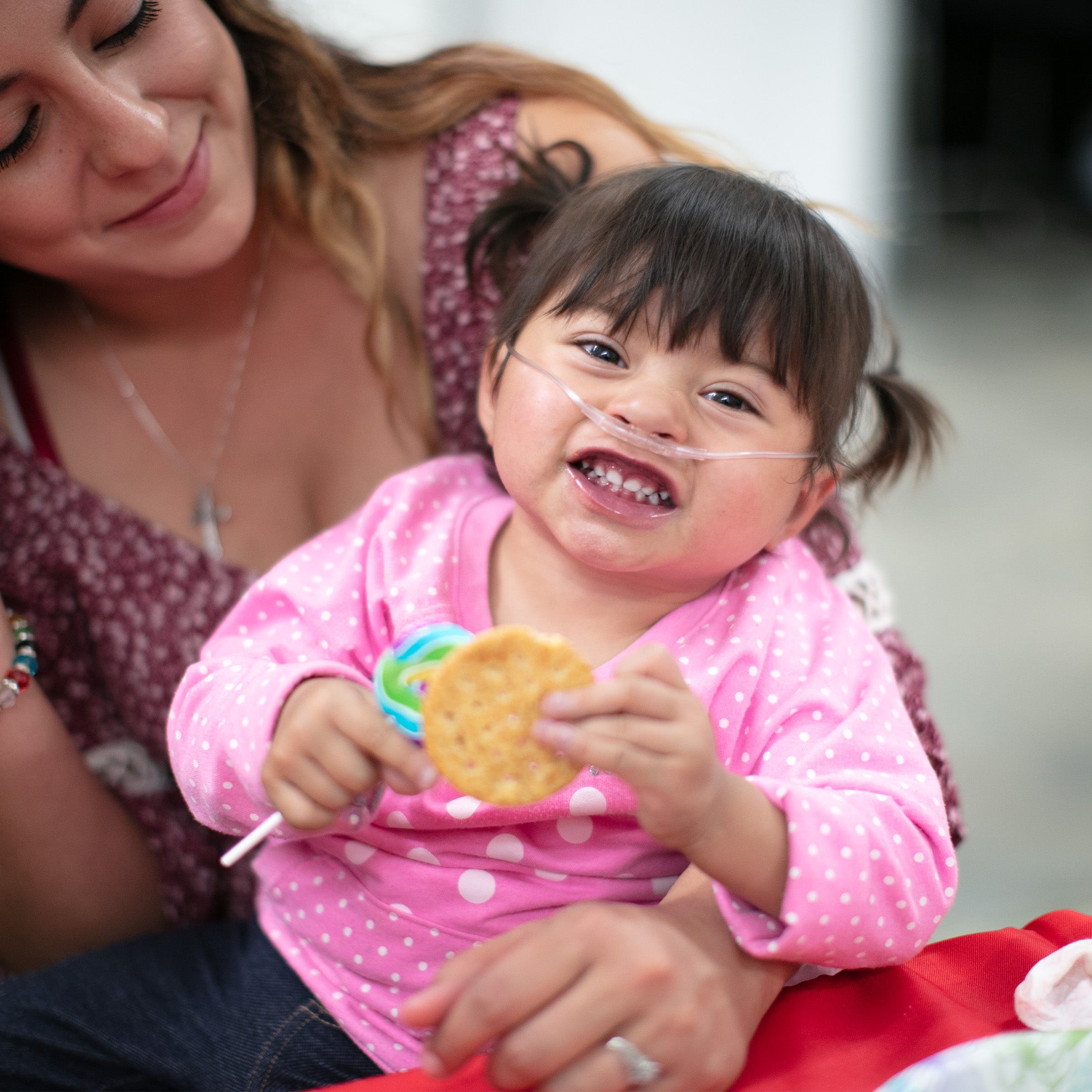 a mom and little girl smiling