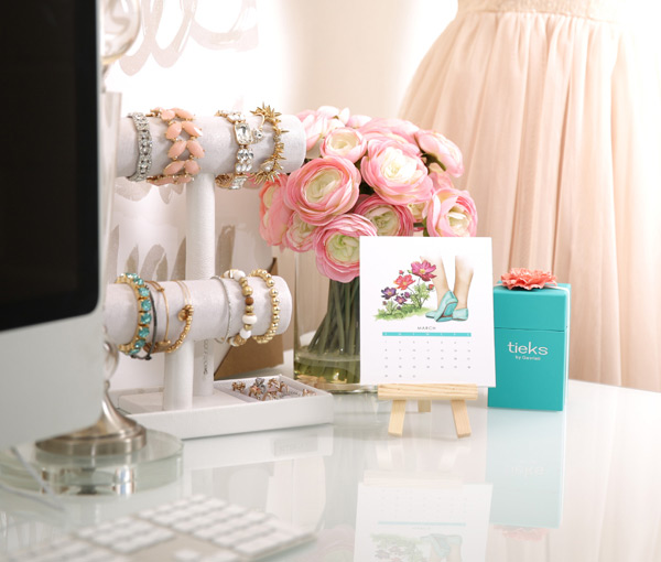jewelry, flowers, calendar, tieks box, and computer on top of a desk