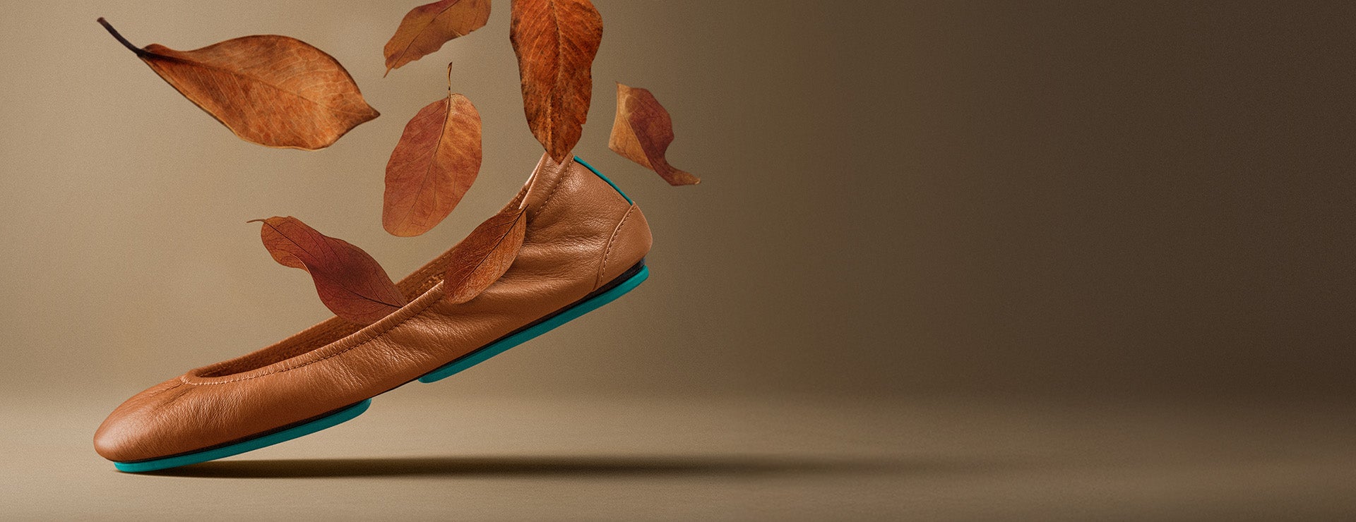 chestnut tieks ballet flats surrounded by falling leaves