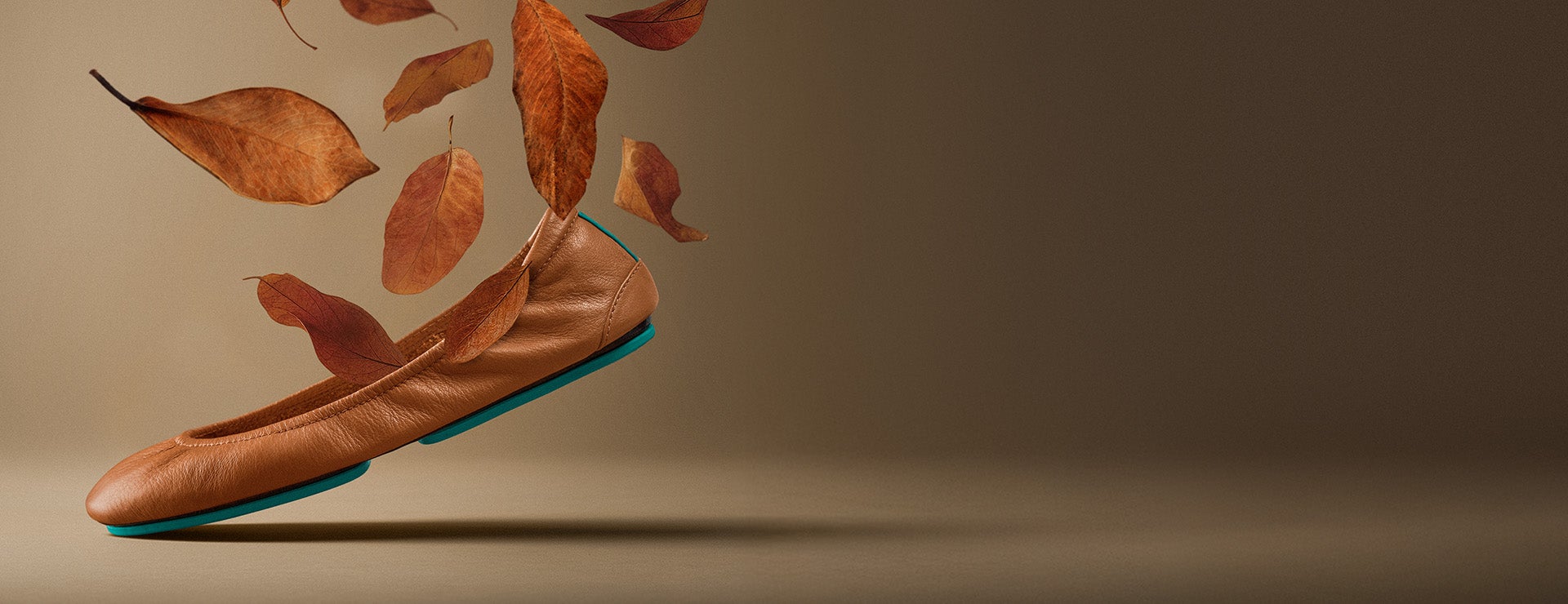 chestnut tieks ballet flats surrounded by falling leaves