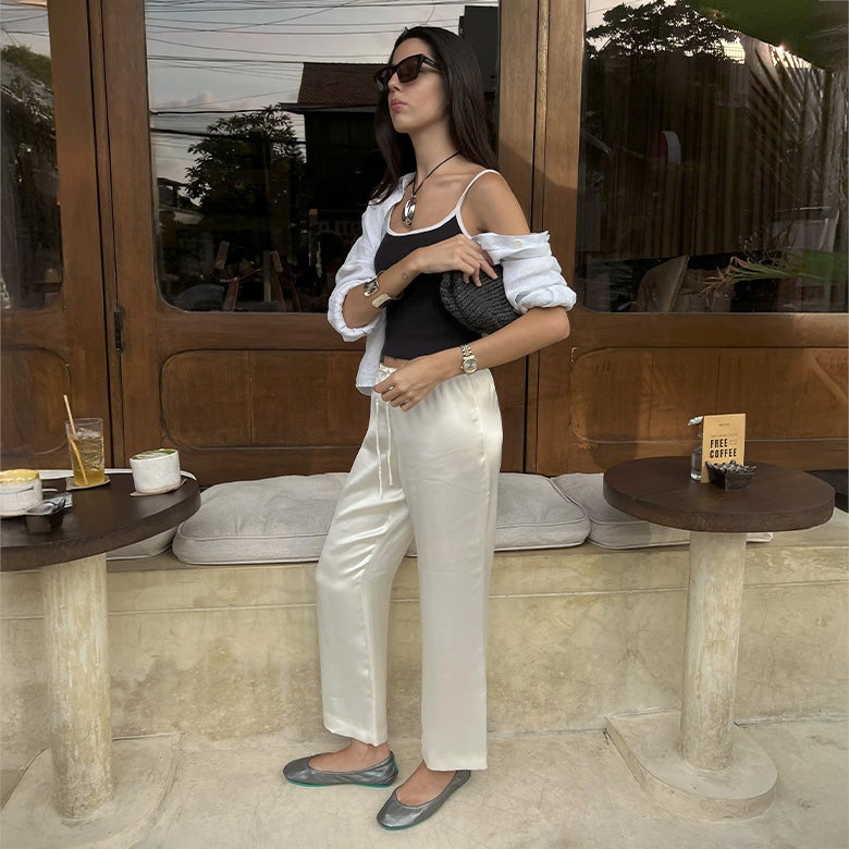 metallic pewter tieks ballet flats styled with satin pants and a black and white top