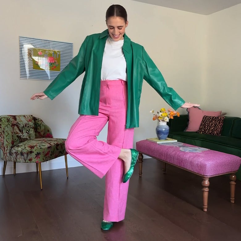 emerald green tieks ballet flats styled with pink pants and a green jacket
