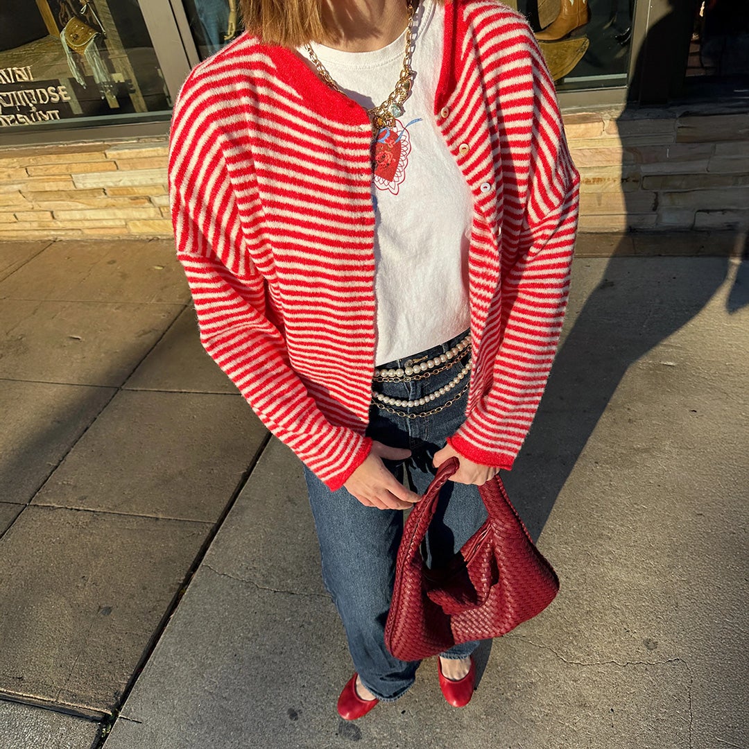 woman wearing cardinal red tieks flats with jeans and a striped red sweater