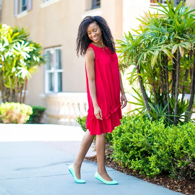 woman wearing a red dress with mint green flats