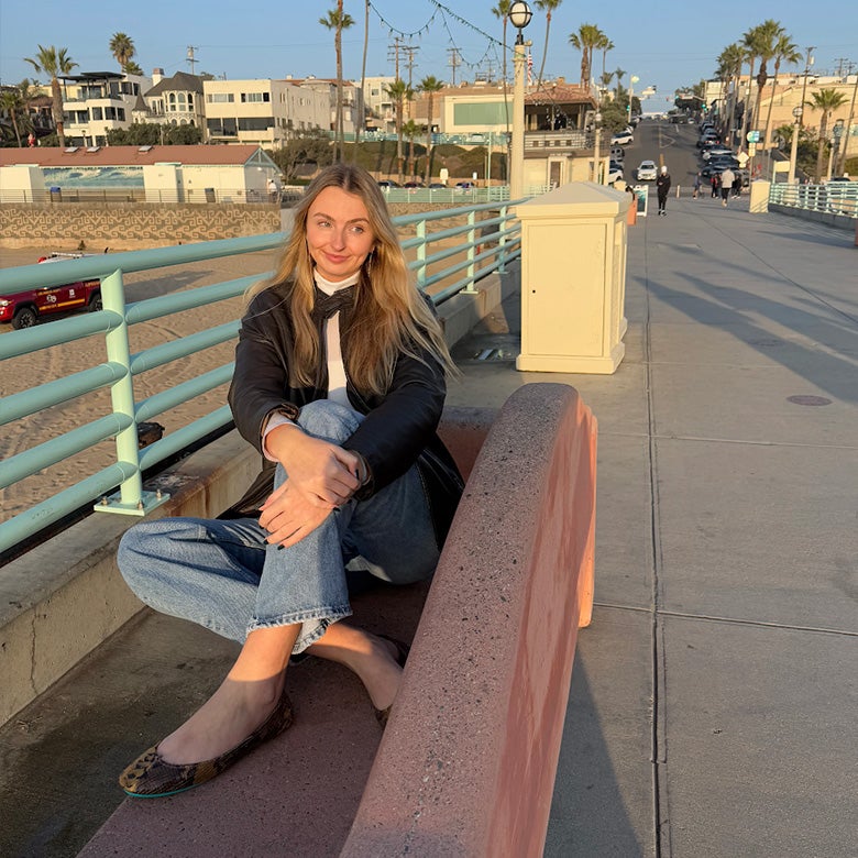 woman wearing mocha snake print tieks flats with jeans