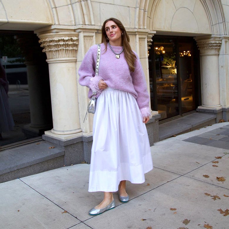 woman wearing a lavender sweater, white maxi skirt, and silver tieks ballet flats