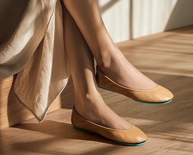 camel tieks ballet flats paired with a neutral skirt