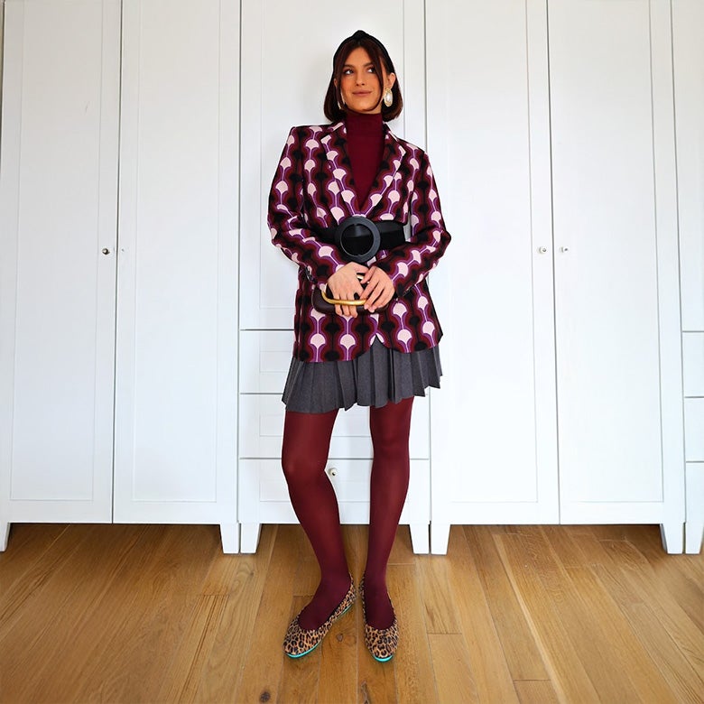 woman wearing leopard print tieks flats with burgundy tights