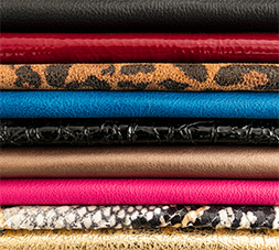 Tieks ballet flats leather displayed as a stack featuring colors: Leopard, Ruby and Cobalt.