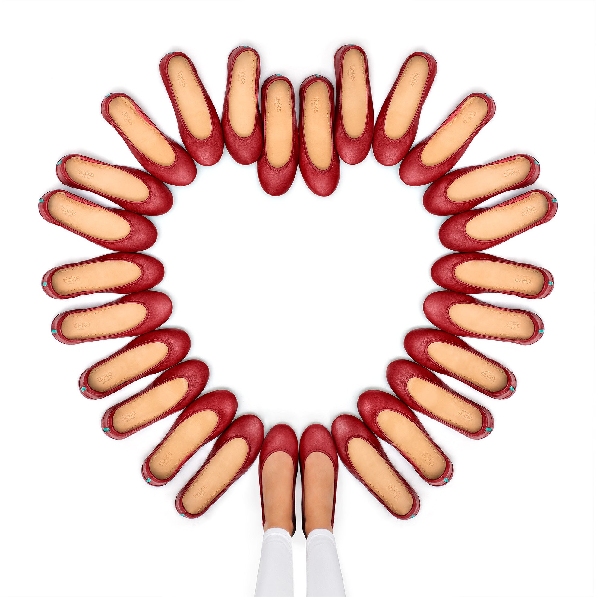 cardinal red tieks flats arranged in a heart shape