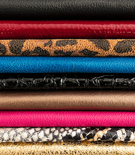 Tieks ballet flats leather displayed as a stack featuring colors: Leopard, Ruby and Cobalt.