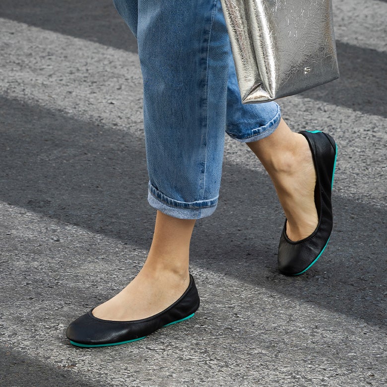 classic black tieks flats styled with jeans