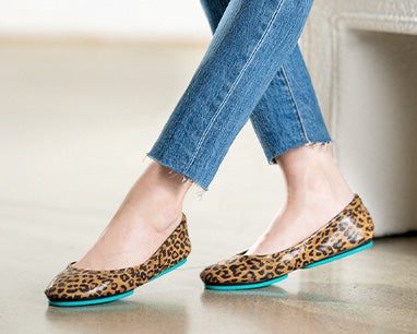 model wearing jeans and leopard print tieks flats
