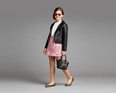 model image of a girl styled in kids leopard print tieks flats