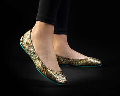 model wearing black leggings and starstruck tieks flats