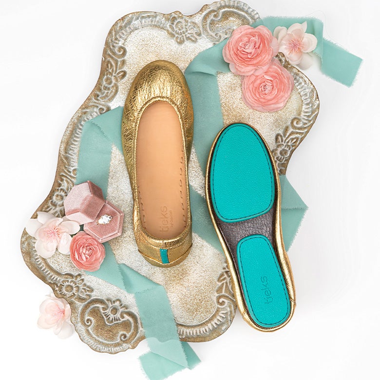 wedding flat lay featuring golden glitz tieks flats