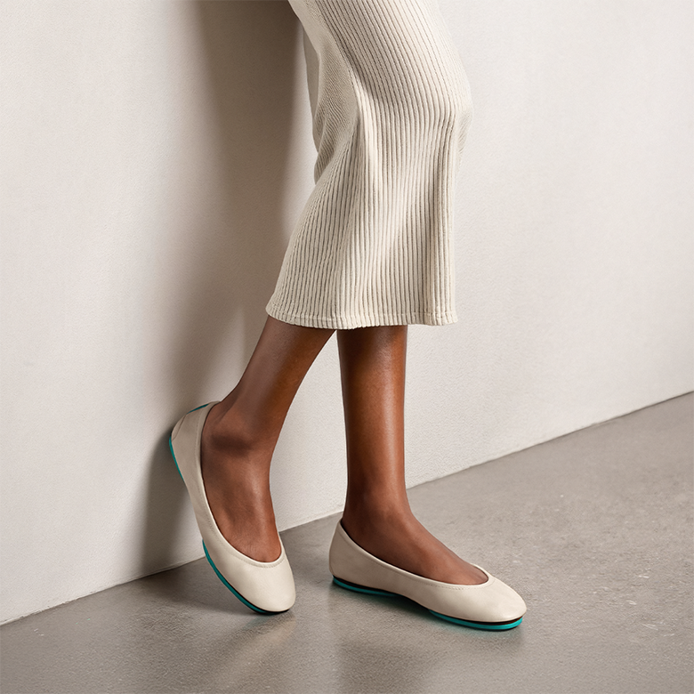 cream tieks flats paired with a cream skirt