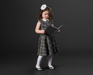 young girl in grey dress and pewter flats